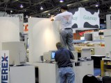 Two guys installing monitors