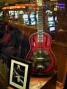 Red guitar in a case with a photo