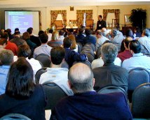 People sitting in a room listening to a speaker