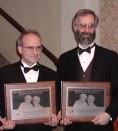 Bob and Dan each in a tux holding an award