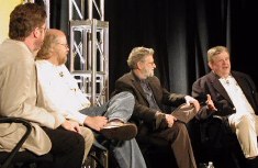 People on stage in chairs