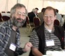 Dan and David at a table in a white tent