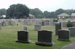 Grass, headstones, trees, sky