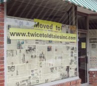 Covered up store window with Moved to www.twicetoldtalesinc.com