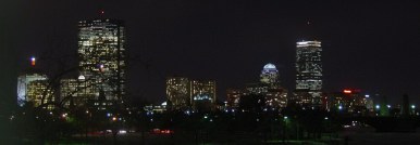 Lit buildings against black sky