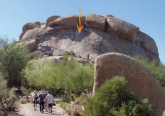 Many-story-high rocks rising pretty vertical in the desert