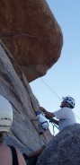 Guy holding rope looking up