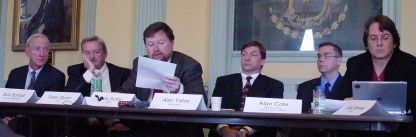 Panelists behind table listening to Bob Sutor among them