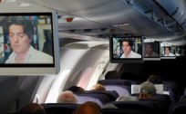 Plane with lots of TV screens showing the movie